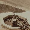 Close-up of fountain from photograph circa 1925. The light on the fountain, shadows stretching both northwest and southeast, and the lack of water in the basin or on the statue suggest the fountain may have been added to the photograph.